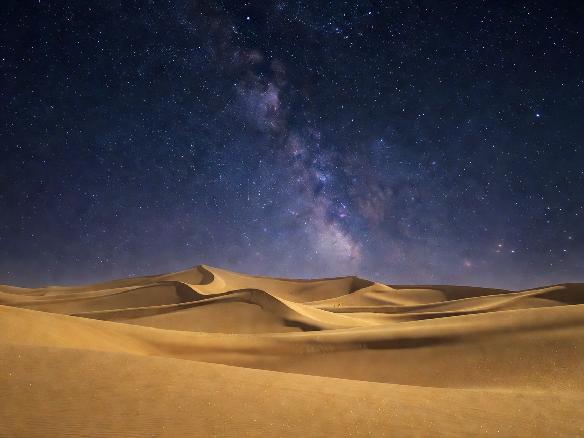 Golden sand dunes under a starry mystical night sky